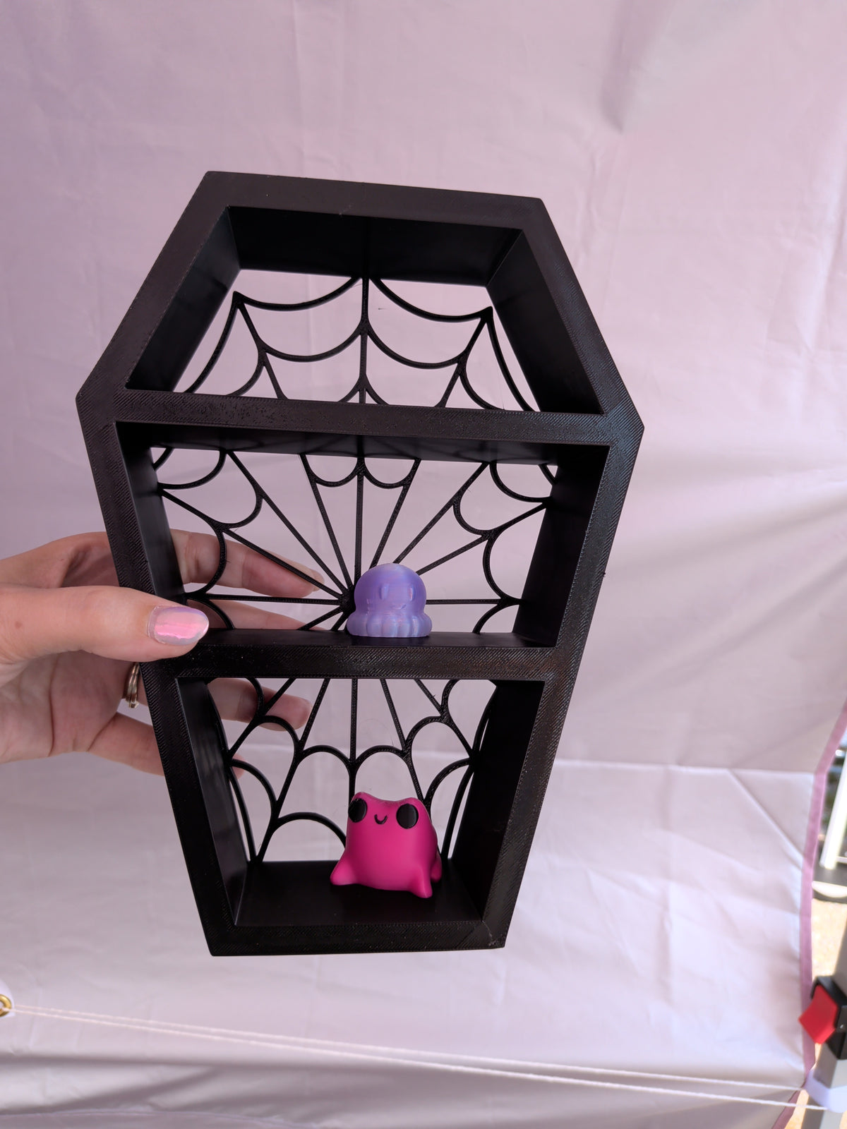 Spider web coffin shelf