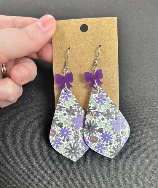 Ravens dangle earrings with purple bow